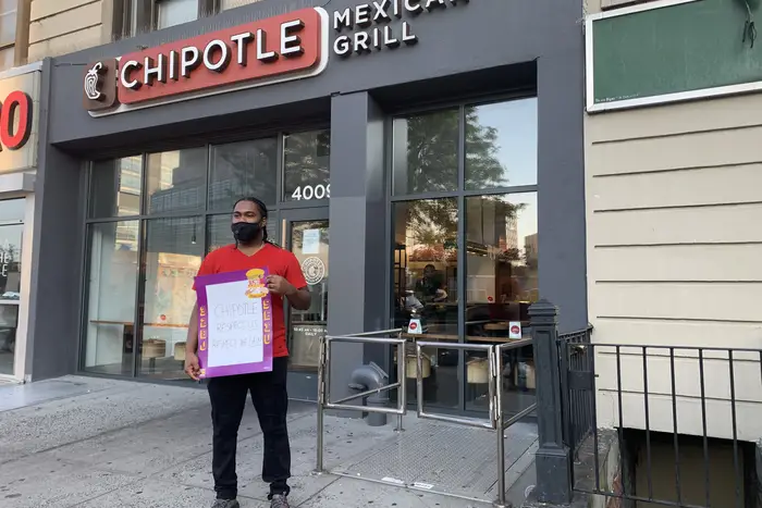 The Chipotle employee stands in front of the burrito chain on August 10th, 2020.